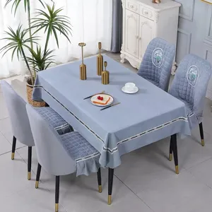 Detail view of blue quilted elastic dining chair covers and matching tablecloth set