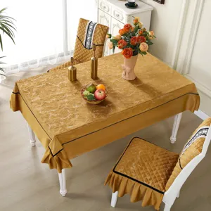 Elegant gold marble pattern chair cover set with matching tablecloth in a dining room