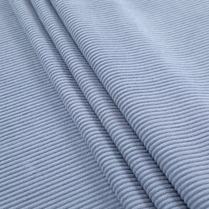 Detailed macro view of light blue thick stretch corduroy fabric for curved dining chair cover