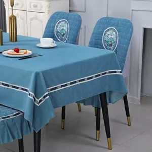 Blue corduroy chair covers and matching tablecloth with elegant floral embroidery detail