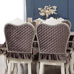 Detailed view of coffee velvet dining chair covers with diamond quilting and lace trim