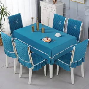 Detail of teal quilted dining table cloth and chair cover set with lace trim