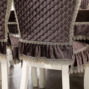 Close-up detail of luxury coffee velvet chair cover with quilted diamond pattern and lace trim