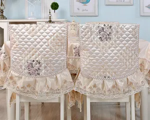 Detailed view of champagne quilted floral chair covers with elegant lace trim and ruffles