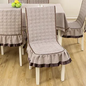 Quilted dining chair covers and matching tablecloth set with elegant ruffled edges