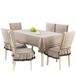Elegant quilted dining table cloth and matching ruffled chair cover set in beige