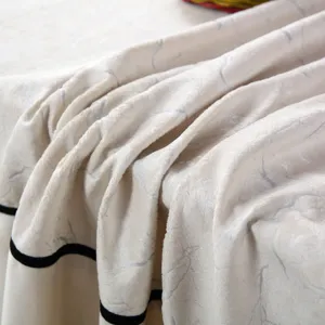 Détail du tissu de la housse de chaise matelassée avec texture marbre gris et bord noir