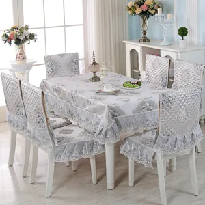Detailed view of elegant European lace tablecloth set with matching ruffled chair covers