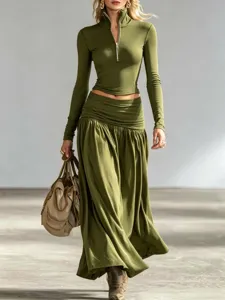 Detail view of stylish olive green long sleeve top and low waist maxi skirt set