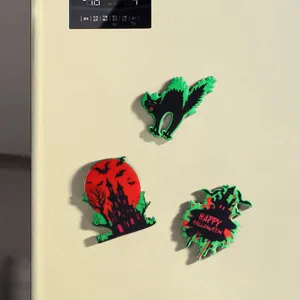 Set of three Halloween themed fluorescent magnetic fridge magnets on refrigerator door