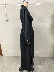 Side view detail of elegant black V-neck maxi dress with puff sleeves on a mannequin