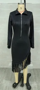 Detailed view of black suede long sleeve dress featuring fringe hem and front zipper detail