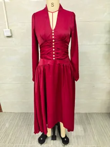 Full length view of elegant wine red V-neck dress with cinched waist detail