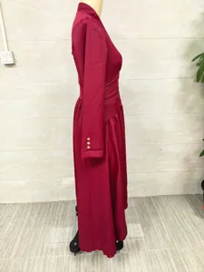 Side view of an elegant burgundy long-sleeved dress with a cinched waist on a mannequin