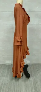 Side view of rust bohemian maxi dress showing ruffled sleeve and irregular hem