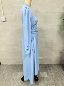 Side profile of an elegant light blue V-neck maxi dress with long puff sleeves on mannequin.