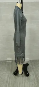 Side profile view of a grey Western-style suede dress with tassel fringe detailing.