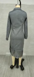 Detailed back view of grey suede long-sleeved dress with fringe hem on mannequin