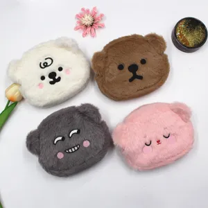 Close-up details of cute plush bear coin purses with lovely embroidered facial expressions.