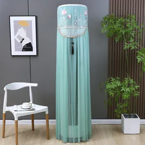 Macro view of light green mesh air conditioner cover featuring delicate pink floral embroidery
