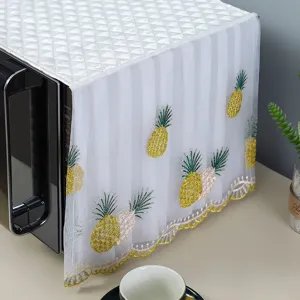 Close-up of white lace microwave cover with pineapple embroidery detail
