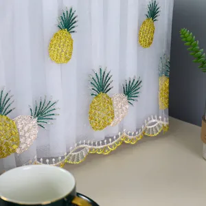 Detail view of white lace dust cover with intricate pineapple embroidery patterns
