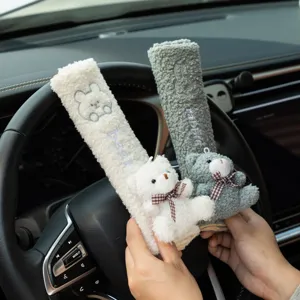 Close-up of cute plush bear and rabbit car seat belt covers with soft fuzzy texture