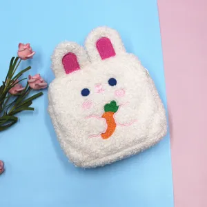 Close-up of a white plush bunny-shaped pouch with a cute carrot embroidery detail