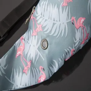 Close-up detail of flamingo and tropical leaf print on a functional sports waist bag