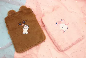 Soft plush iPad sleeves in brown bear and pink pig designs on starry background