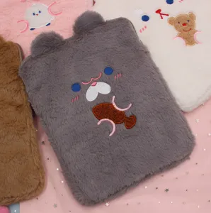 Close-up detail of cute plush iPad sleeve with embroidered animal face and soft fur texture