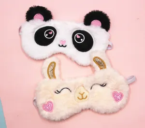 Detail shot of plush panda and alpaca sleep masks with cute embroidered animal features