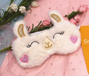 Macro detail of plush alpaca sleep mask with sequin ears and heart patches