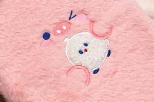 Detail view of high-quality embroidery on pink faux fur iPad protective sleeve