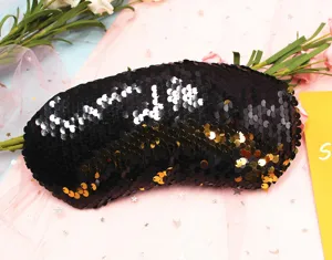 Close-up detail of reversible black and gold sequins on a mermaid-style sleep mask