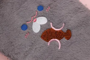 Detailed macro view of the cute cat embroidery on a grey soft plush tablet sleeve bag