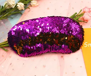 Close-up of reversible purple and black sequins on a mermaid style travel eye mask