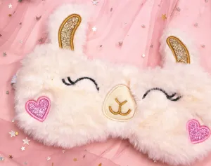 Close-up of plush alpaca sleep mask with pink heart patches and gold ears