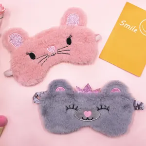 Detailed view of pink and grey plush animal sleep masks with soft fur texture.