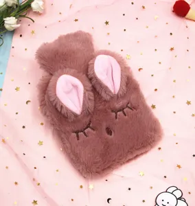 Cute pink plush rabbit hot water bottle cover with soft ears and sleeping face detail