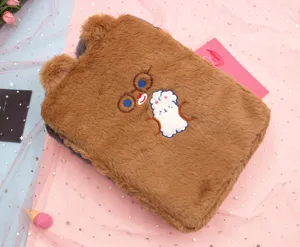 Detailed close-up view of a cute brown plush iPad sleeve with bear embroidery and decorative ears