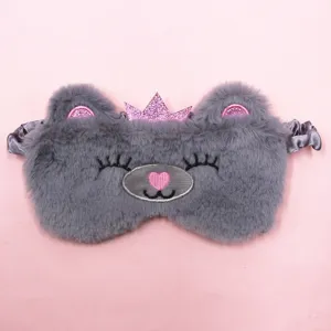 Close-up of cute gray plush bear eye mask with pink glitter crown for sleep