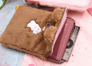 Plush 11-inch iPad sleeve with cute bear embroidery shown holding multiple books for capacity.