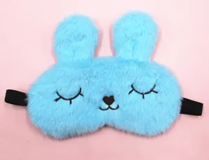 Detailed view of a cute light blue plush bunny sleep mask with soft fur texture and ears.