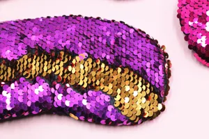 Macro detail showing reversible purple and gold sequins on a mermaid scale eye mask