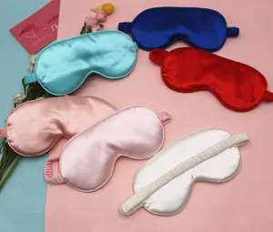 Detailed close-up view showing multiple colors of soft silk sleep masks for eyes