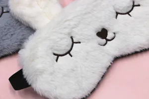 Macro detail showing the soft plush texture and embroidered rabbit face eye mask