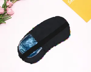 Dettaglio del retro in tessuto nero e del gel pack blu della maschera di paillettes