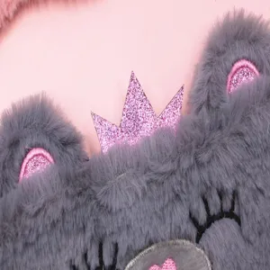 Close-up of a cute plush grey bear sleep mask featuring a sparkling pink glitter crown detail
