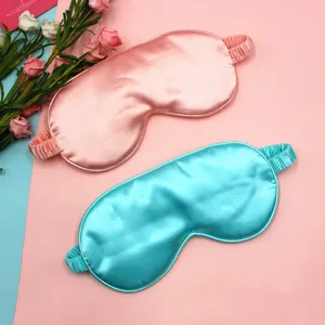 Premium silk sleep masks in pink and blue colors featuring smooth texture and elastic straps